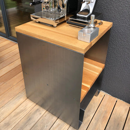 Siebträgermaschine und Barista-Zubehör auf der Eichenplatte des seitlich offenen Tischs